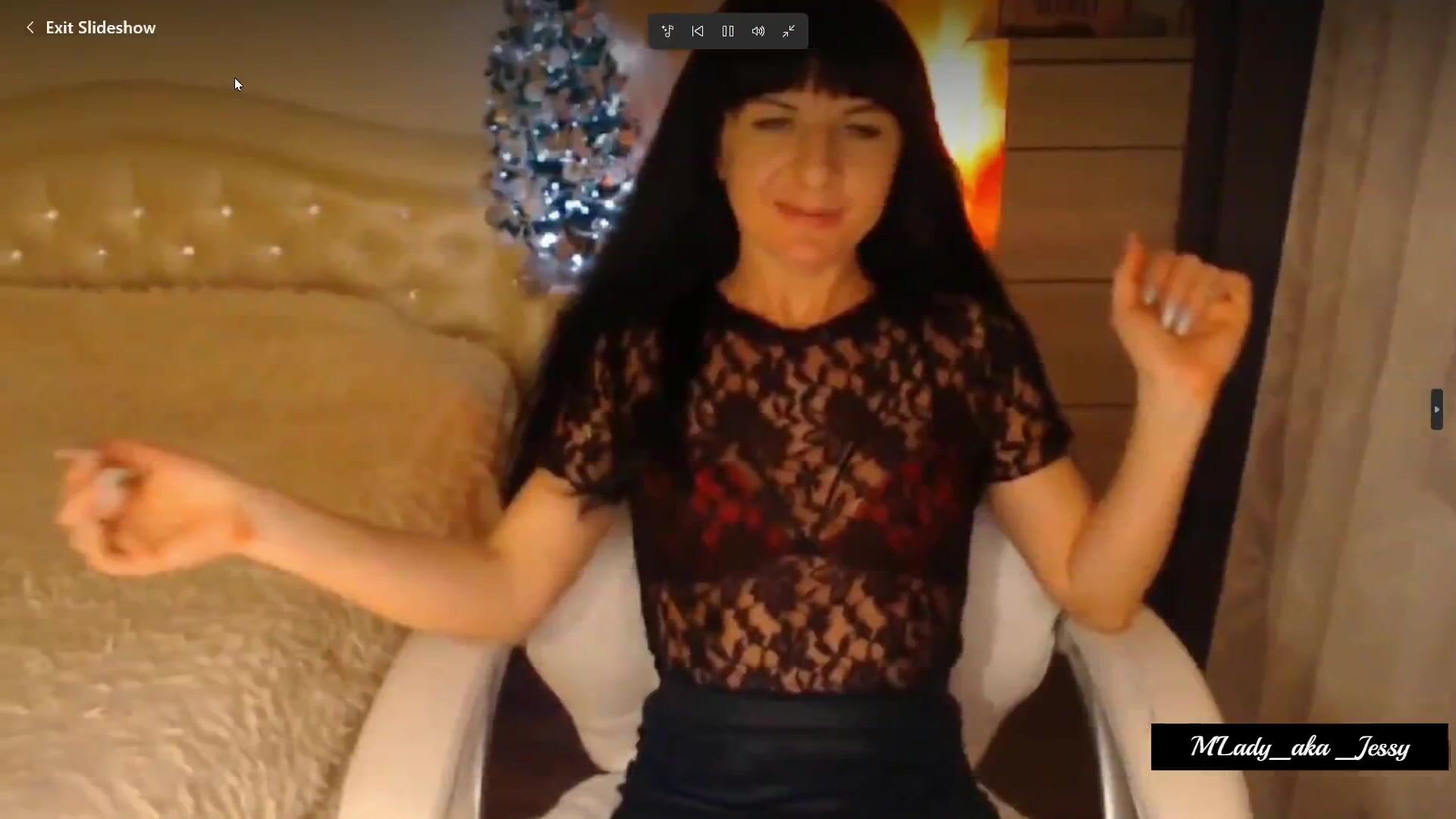 Sexy brunette Jessy, M'Lady, teases in her chair, opens her legs, slips hand inside p